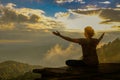 Backlit silhouette of healthy woman balancing meditation and yoga outdoor zen energy on bridge in mountain nature morning Royalty Free Stock Photo