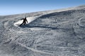 Backlit silhouette of man in action practicing ski going fast and agressive down snow slope winter sport