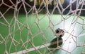 Backlit soccer ball in a goalpost