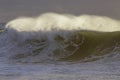 Backlit stormy wave spray at sunset