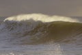 Backlit stormy wave spray at sunset