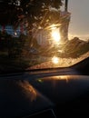 Backlit sunset rainy raindrops on windshield summer