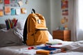 Backpack bag and school supplies on the bed, blurred background. Royalty Free Stock Photo