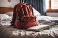 Backpack bag and school supplies on the bed, blurred background. Royalty Free Stock Photo