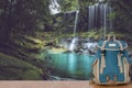 Backpack and beautiful waterfall landscape background