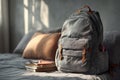 Backpack on bed with books cozy room still life warm light Royalty Free Stock Photo