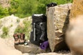 Backpack and camping equipment on rocks Royalty Free Stock Photo
