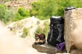 Backpack and camping  on rocks in wilderness. Space for text Royalty Free Stock Photo