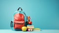 Backpack with different colorful stationery and apple on table and blue background. Banner design back to school concept Royalty Free Stock Photo