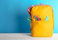Backpack with different colorful stationery Royalty Free Stock Photo