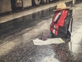 Backpack, hat, cellphone and map on floor at the station Royalty Free Stock Photo