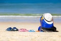 Backpack, hat and flip-flops bu family on the tropical beach. Concept family vacation.