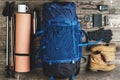 Backpack and hiking equipment on wooden background, top view Royalty Free Stock Photo