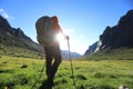 Backpack hiking in sunrise high altitude mountains Royalty Free Stock Photo