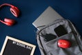 Backpack with laptop, smartphone, mouse and an external ssd on a blue next to the headphones and inscription my shool bag. Concept Royalty Free Stock Photo