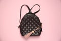Backpack with leather keychain on pink background, top view Royalty Free Stock Photo