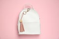 Backpack with leather keychain on pink background, top view Royalty Free Stock Photo