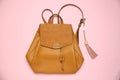 Backpack with leather keychain on pink background, top view Royalty Free Stock Photo