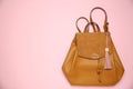 Backpack with leather keychain on pink background, top view. Space for text Royalty Free Stock Photo