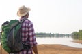 A backpack man standing on the river and see over view in nature. Royalty Free Stock Photo