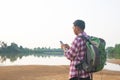 A backpack man standing on the river and see over view in nature. Royalty Free Stock Photo