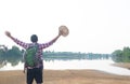 A backpack man standing on the river and see over view in nature Royalty Free Stock Photo