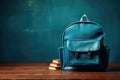 Backpack and notebooks on table on blue tone background, back to school. Generative ai