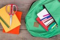 Backpack and school supplies: books, notepad, felt-tip pens, scissors