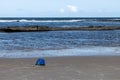 A backpack and shoes abandoned on the lonely beach Royalty Free Stock Photo