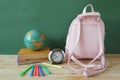 Backpack with supplies for school on the background of blackboard. Copy space for text. Back to school Royalty Free Stock Photo