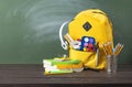 Backpack, textbooks, stationery and school supplies on desk