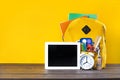 Backpack, textbooks, stationery and school supplies on wooden desk