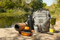 Backpack, thermos, gas burner, sleeping mat, knife, compass and tourist utensils in the mountains. Royalty Free Stock Photo