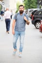 Backpack for urban travelling. Hipster wearing backpack urban street background. Bearded man travel with backpack. Guy Royalty Free Stock Photo