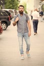 Backpack for urban travelling. Hipster wearing backpack urban street background. Bearded man travel with backpack. Guy Royalty Free Stock Photo