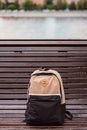 The backpack is on a wooden bench in the Park Royalty Free Stock Photo