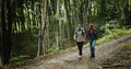 Backpacked Couple Walking in Forest