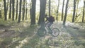 Backpacked man rides bicycle in the forest