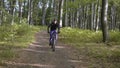 Backpacked Man Rides Bicycle in the Forest