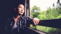 Backpacker Asian woman tired from train travel transportation. Royalty Free Stock Photo