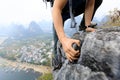 Backpacker climbing rock on mountain top cliff edge Royalty Free Stock Photo