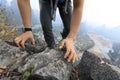 backpacker climbing rock at mountain top cliff edge Royalty Free Stock Photo