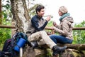 Backpacker couple taking rest aside hiking trail Royalty Free Stock Photo