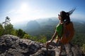 Backpacker enjoy the view on mountain top cliff edge Royalty Free Stock Photo