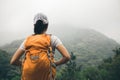 Backpacker enjoying the view on morning mountain valley