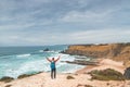 Backpacker enjoys his hike along the Fisherman Trail, Portugal. View of Alteirinhos Beach near Zambujeira do Mar, Odemira region.