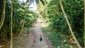 Backpacker exploring alone trail in the tropical jungles at Manadhoo island capital of Noonu atoll