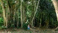 Backpacker exploring alone tropical jungle forest at Manadhoo island capital of Noonu atoll