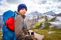 Backpacker female tourist standing alone mountain cliff ridge edge landscape