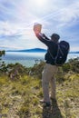 Backpacker freelancer with laptop over mountain